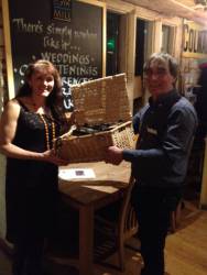 Serena Oborne is seen here receiving the hamper from Peter Angell of our club 